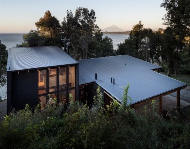 flat roof of wooden home surrounded by trees