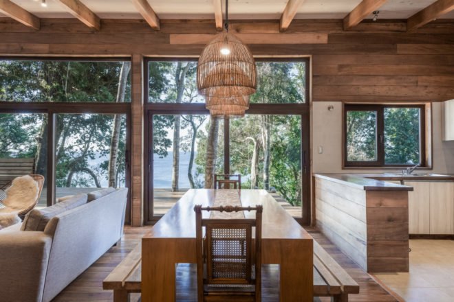 an interior space with dining table and glass windows
