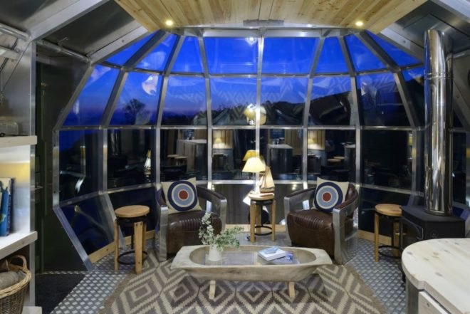 a domed glass wall with seating on the interior