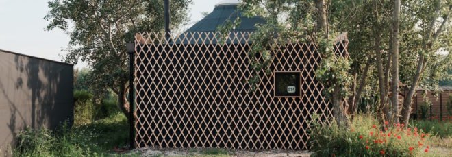 dark cabin with light timber lattice exterior