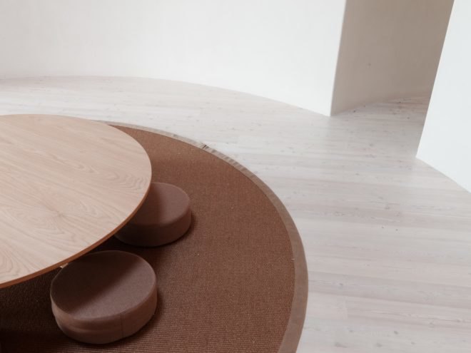 round table and rounded seats on a brown round rug in the round room