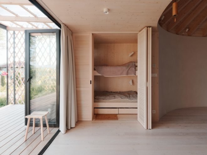timber bunk beds behind light timber folding doors