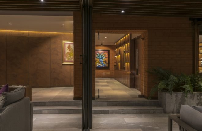 Interior of home with concrete floors and large works of art on the walls