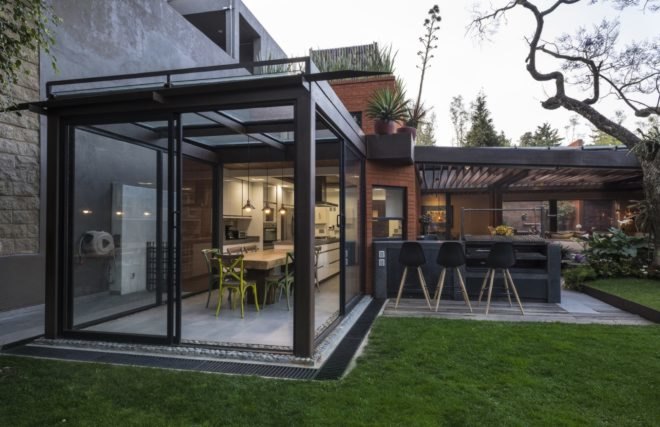 kitchen with full-height sliding doors opened up to outdoor yard and terrace