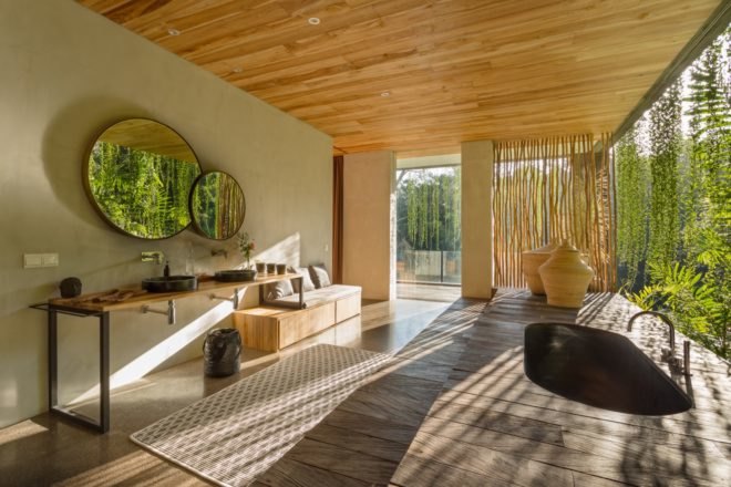 bathroom with large soaking tub near glass wall