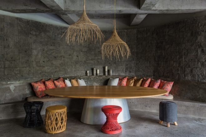 intimate seating area with bright pillows in a concrete space