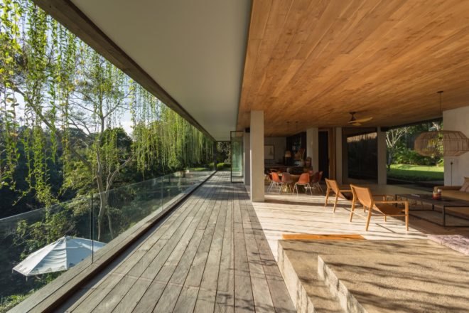 Indoor seating areas open to an outdoor covered balcony
