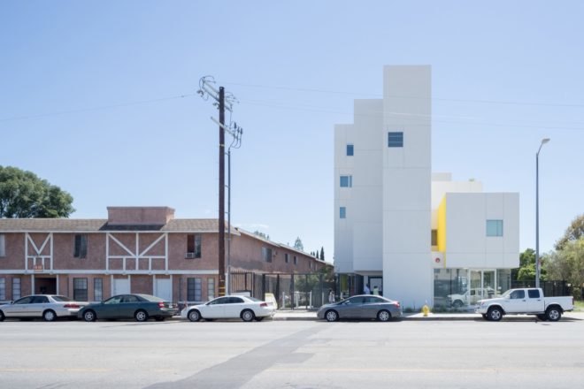 street side view of white apartment building