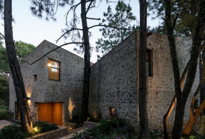 stone home surrounded by trees