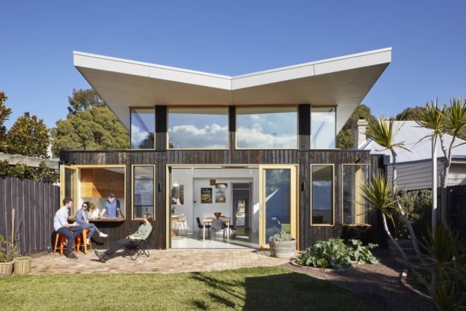 exterior of the extension with butterfly roof and dark timber cladding