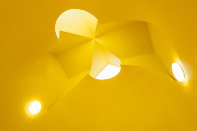 top of the bright yellow stairwell with skylights