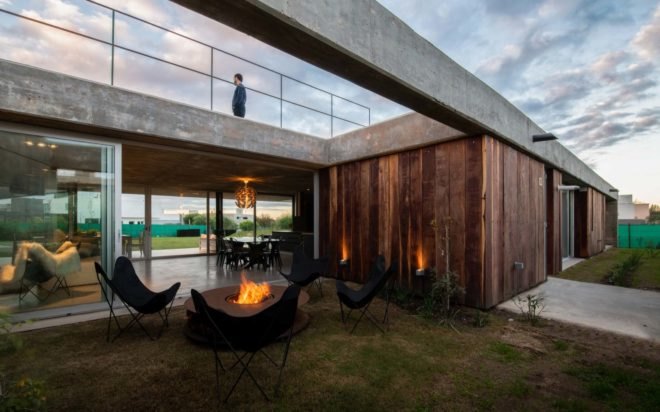 man standing on concrete roof of indoor outdoor home