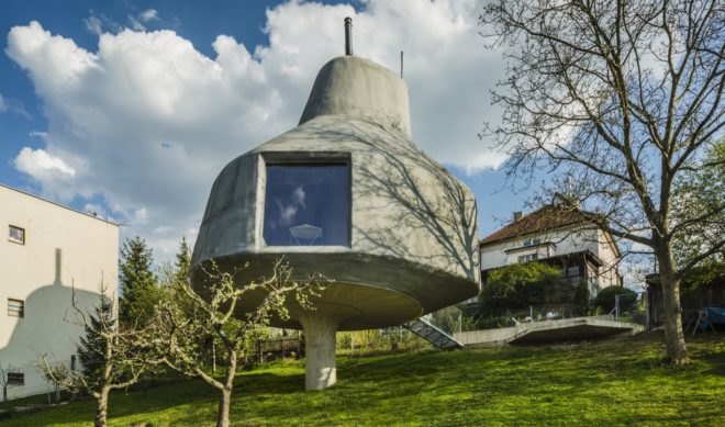 large gray home on a pillar