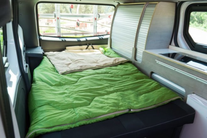 sleeping space with green bedspread in popup roof