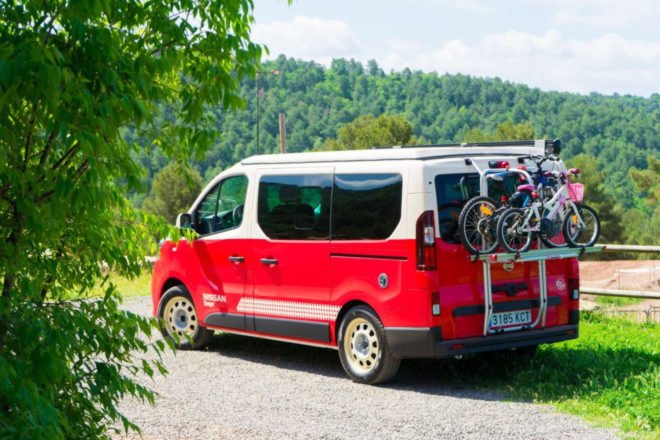 red camper van with bikes on the back