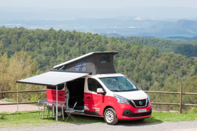 a red camper van with a popup roof