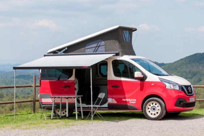red camper van with pop up roof and exterior eating space