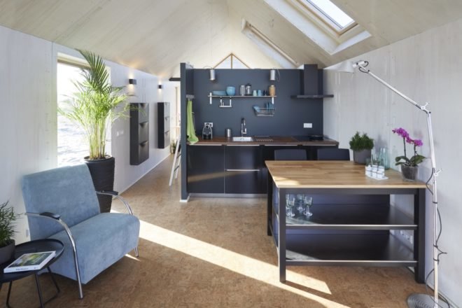 open plan living area of tiny house with sofa and table