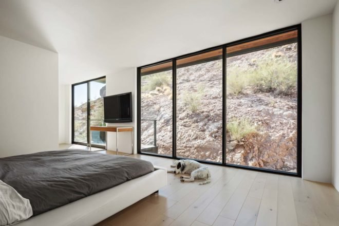 bedroom with view of desert mountainside