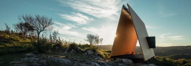 open timber chapel on a hill