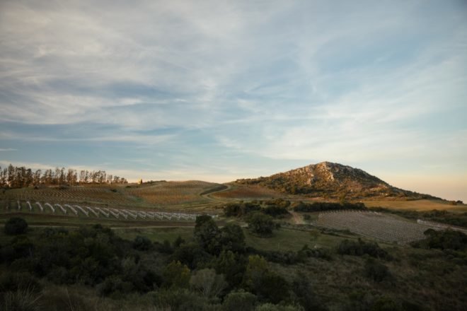 timber chapel on hill in the background
