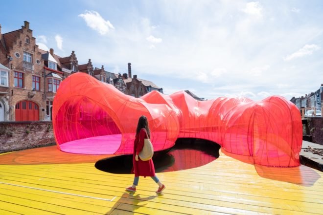 Person walking along yellow walkway of pavilion