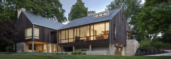 wood, stone and glass farmhouse-style home