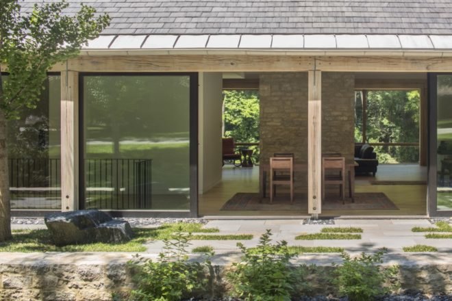 sliding glass doors lead to stone outdoor walkway