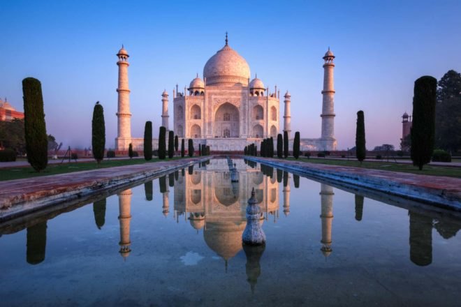the taj mahal and reflecting pool at dusk