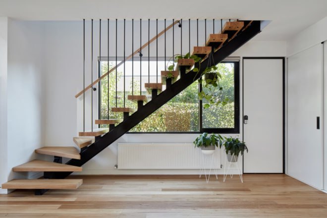 Wooden staircase in front of window
