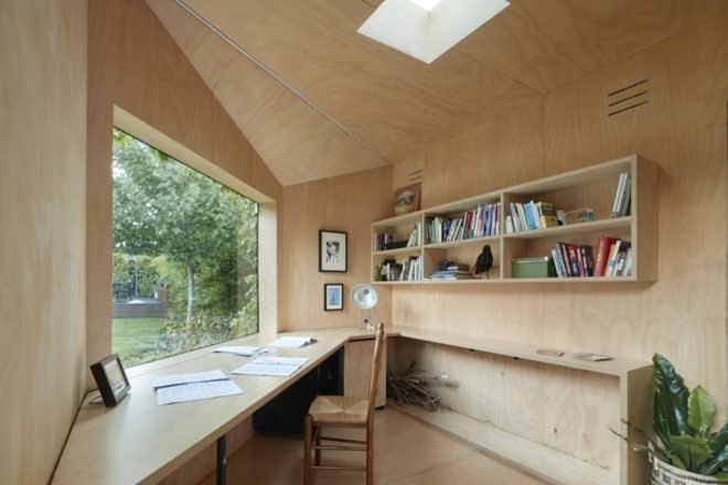 interior light timber workspace with large desk and wall shelving