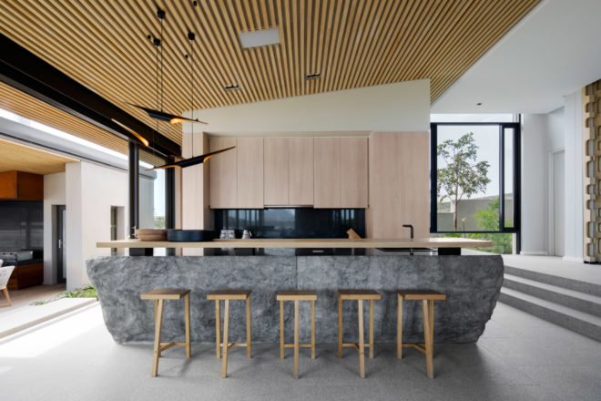 Kitchen with granite island and wooden stools