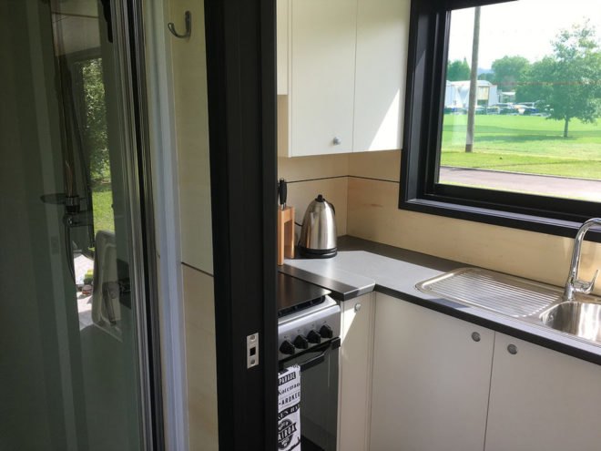 Kitchen details including steel sink and full-size stove