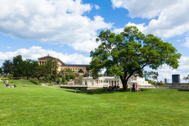 Philadelphia art museum park with people lounging in the grass