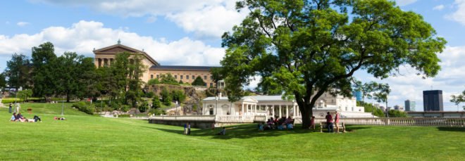 Philadelphia art museum park with people lounging in the grass