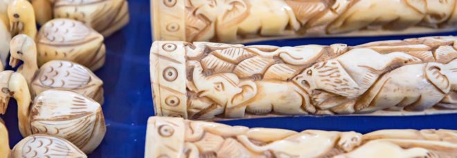 Carved ivory products on a blue blanket