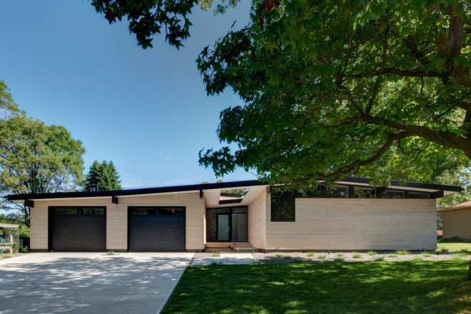 Light wood one-story home with two garages