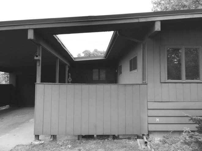 Black and white photo of old porch