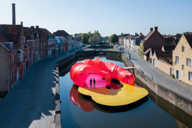 Pink and yellow floating pavilion in Bruges canal
