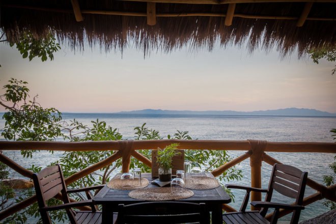 Dining table with views of the ocean at dusk