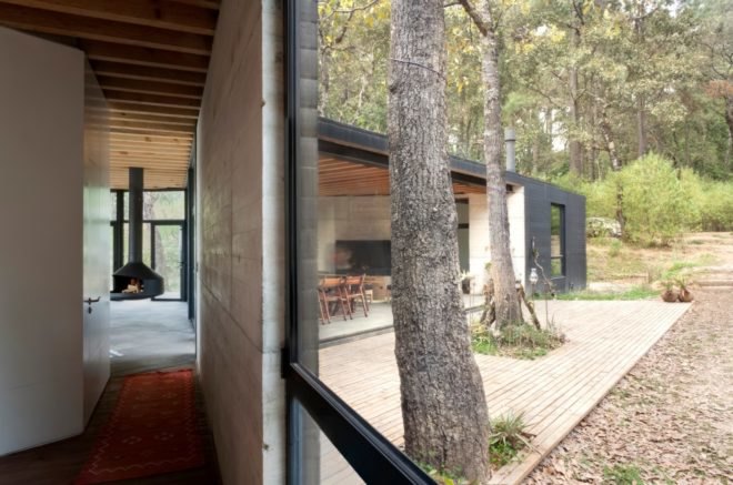 an interior and exterior shot of home with large windows
