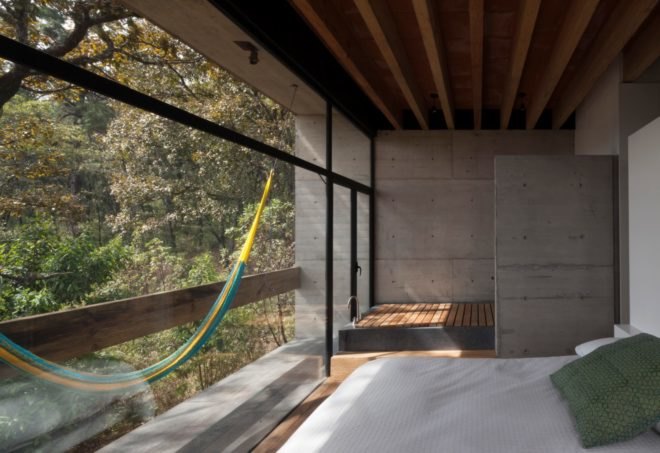 a bedroom with hammock and floor-to-ceiling walls