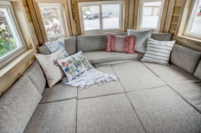 a grey sofa bed with cushions