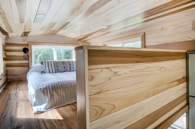 a sleeping loft clad in wood paneling