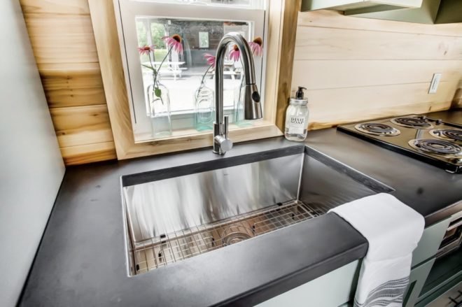 a large sink set into a concrete countertop