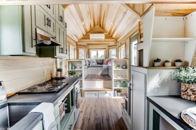 an interior view of a living space with kitchen and elevated sofa