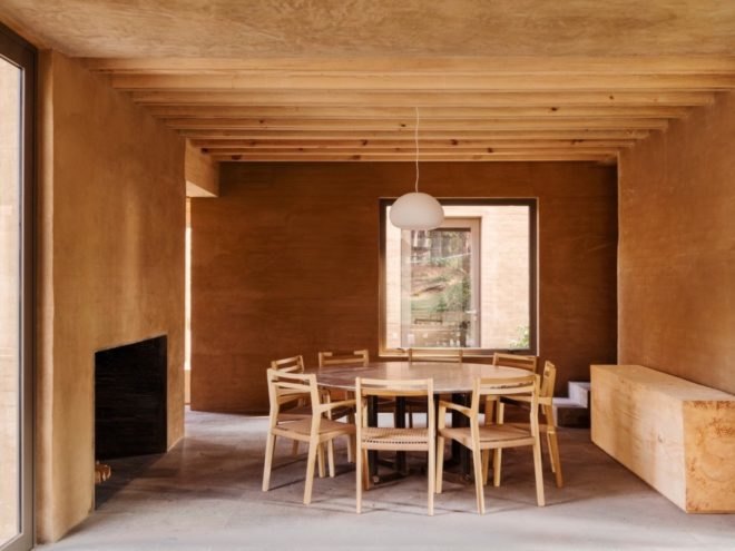 dining area with wood beam ceiling and large round table