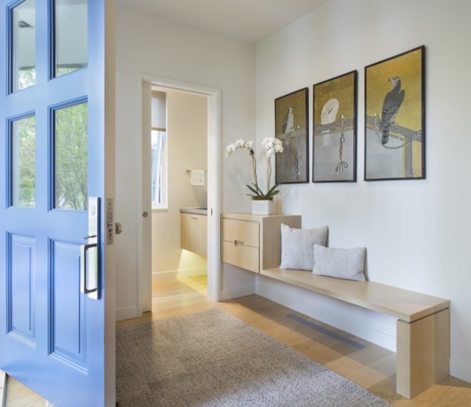 entrance with modern bench and three framed artworks of birds