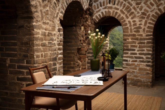 desk for calligraphy with brick archways in background
