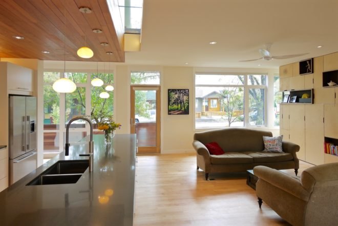 open floor living room and kitchen with built-in storage wall and large kitchen island